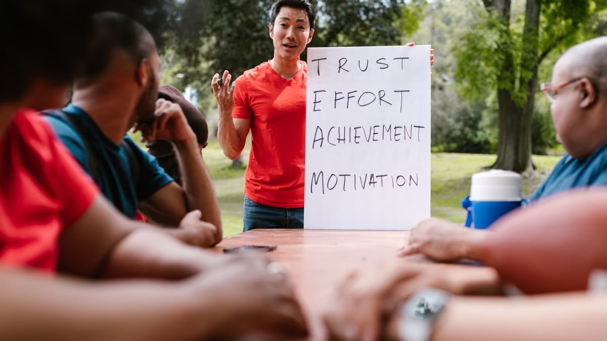 Diverse group engaged in outdoor team building, highlighting trust and effort.